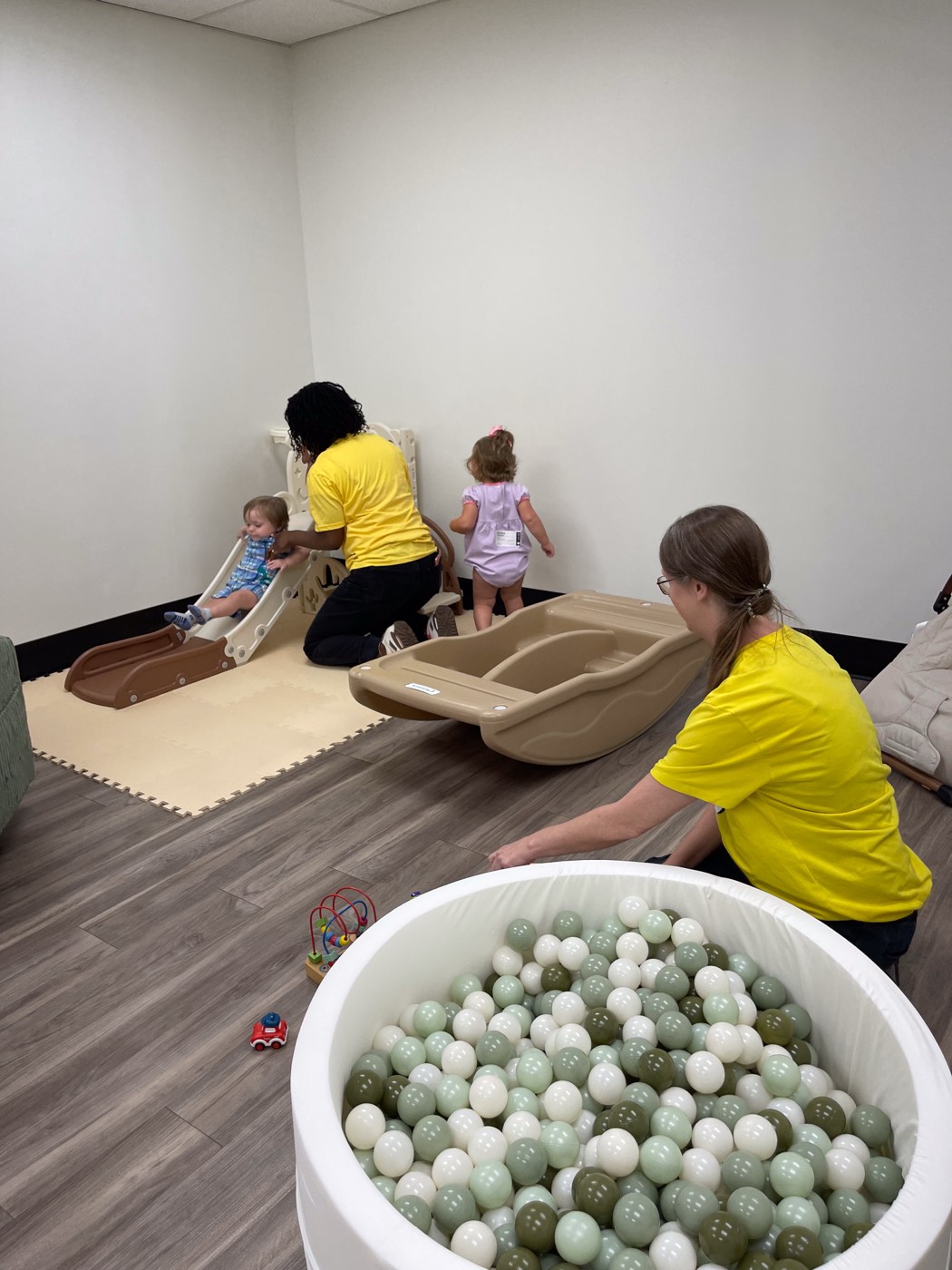 Volunteers with toddlers in the nursery