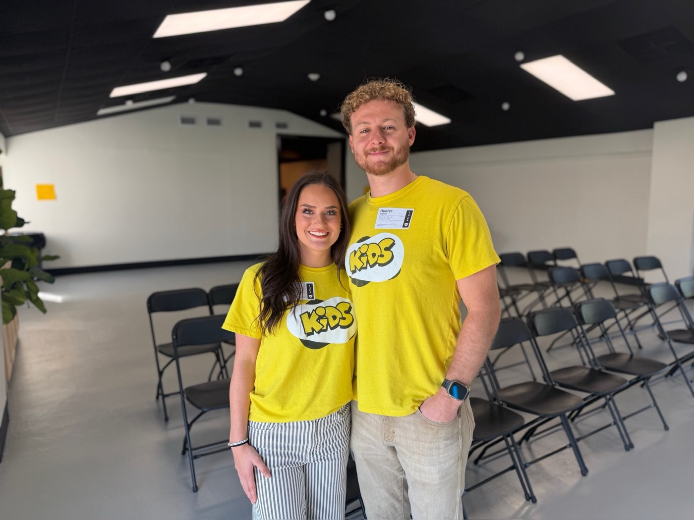 Two kids ministry volunteers laughing