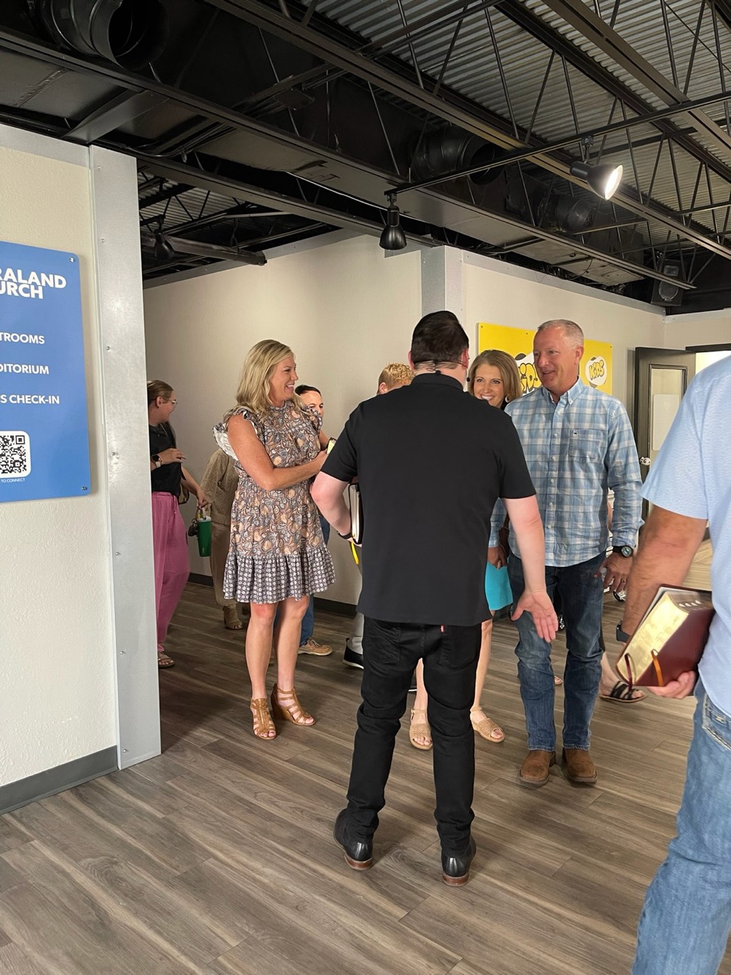 Pastor Jason greeting guests in the lobby