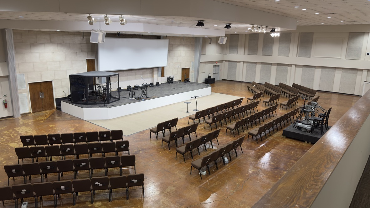 The auditorium before the renovation, with a bare concrete floor