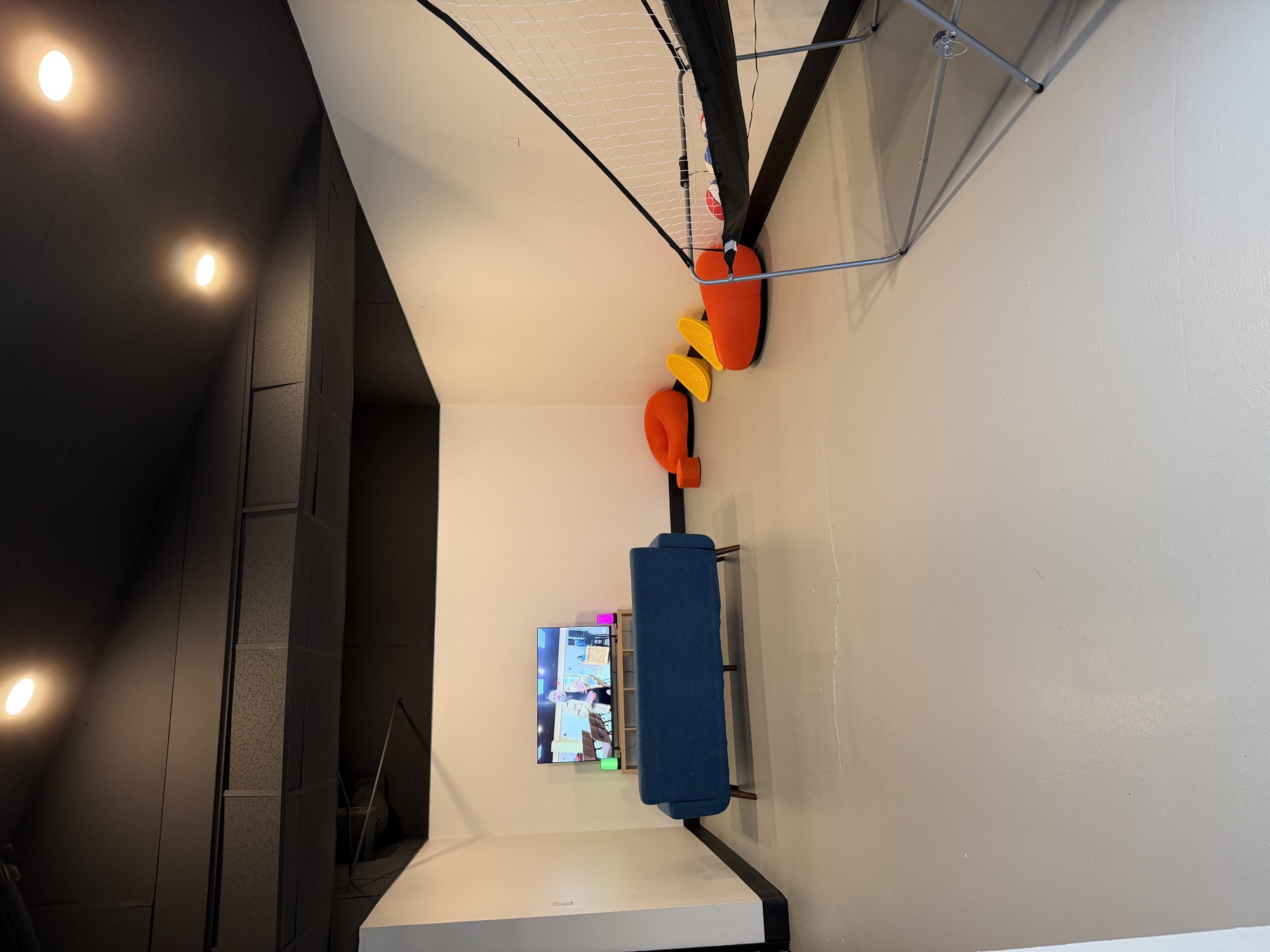 A lounge in the Loft with a couch, TV and bean bags
