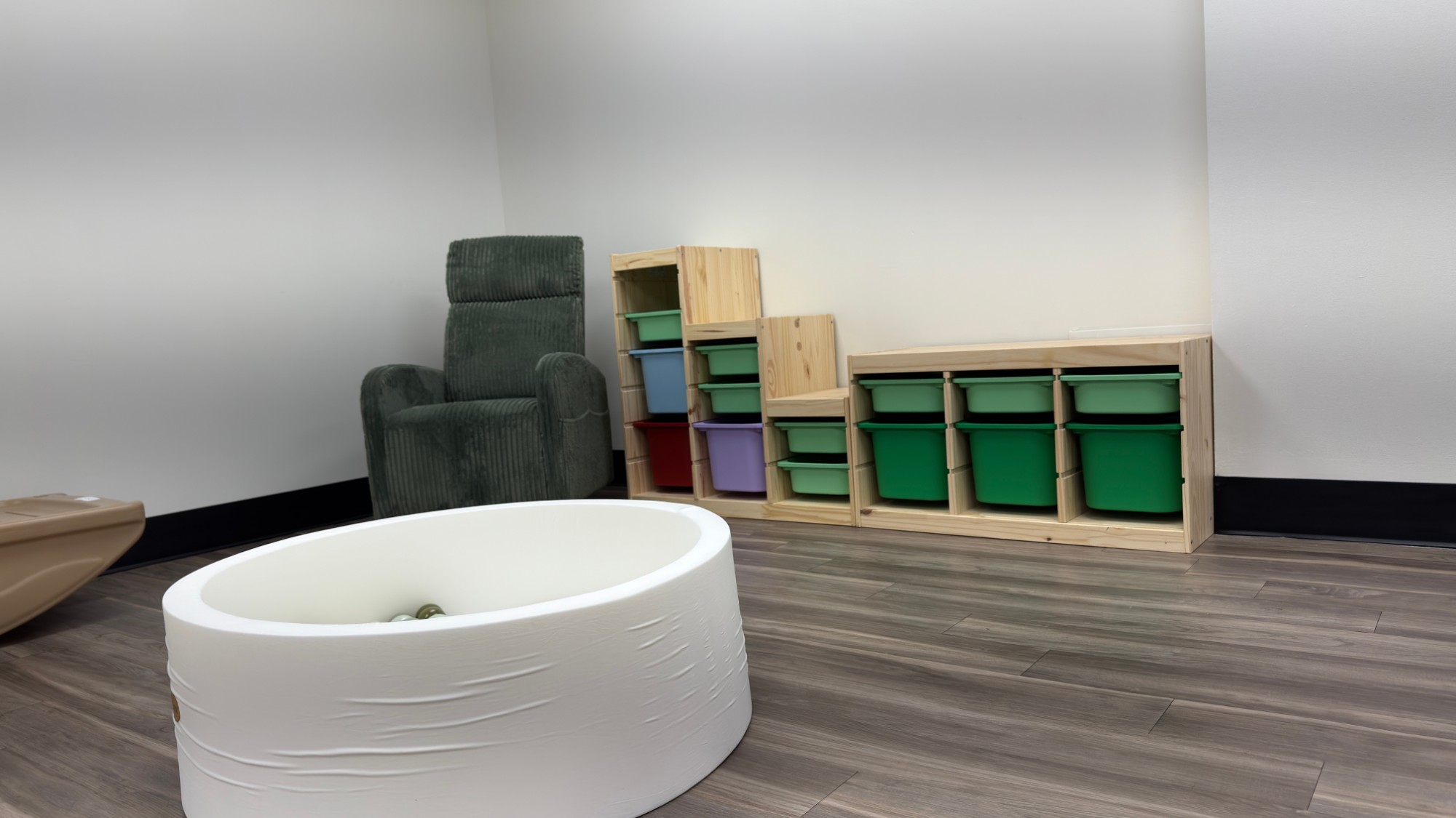 The renovated nursery with a ball pit, rocker and toy bins